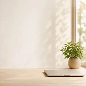 Minimalist workspace desk with closed laptop and a small green plant