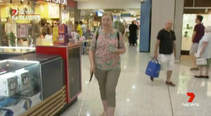 A woman with a cane uses BindiMaps to navigate around a shopping centre.