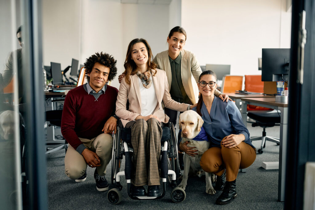 Snippet of coworkers with diverse needs smiling at the camera. 